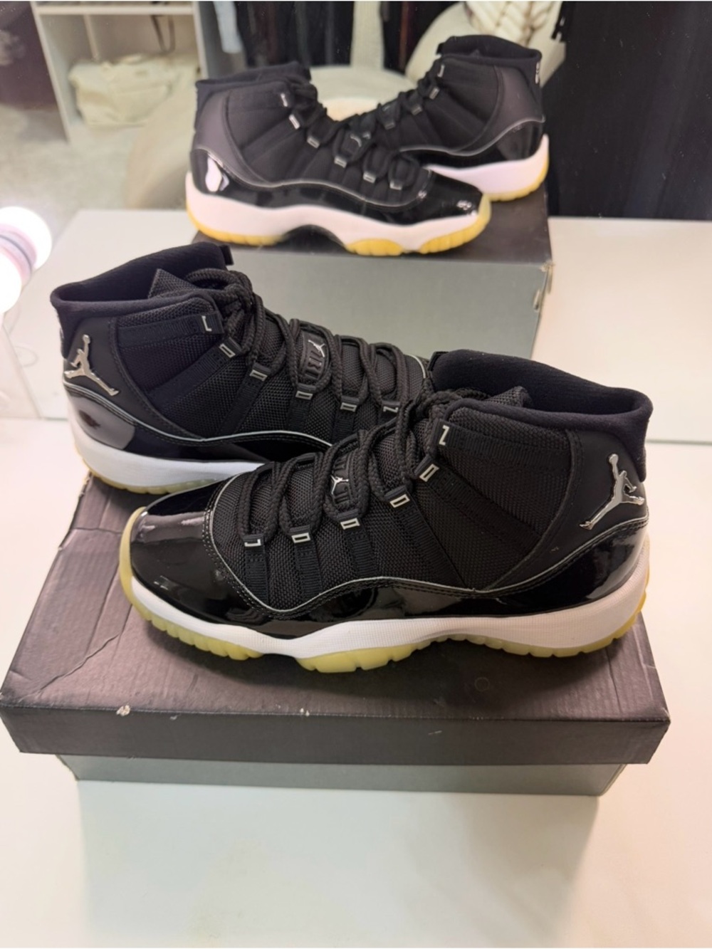 Jordan 11’s jubilee Black Patent Leather High-Top with Yellow Outsole.
